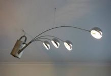 André Stache took a used watering can and upcycled it together with 4 lights into an amazing pendant that looks like it sprinkles 'light' into the room. – upcycleDZINE