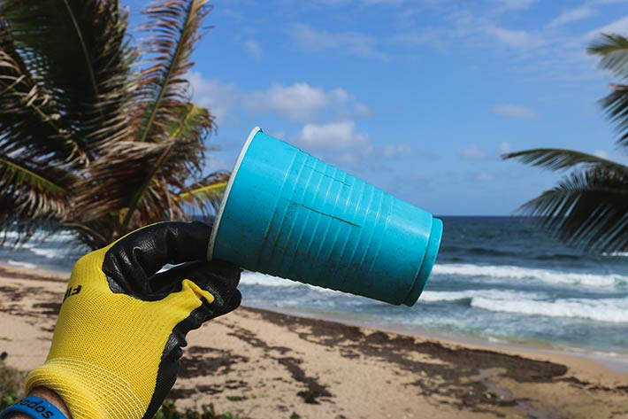 Plastic cup on beach