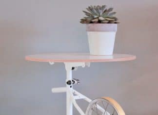 Kids bicycle turned into a white coffee table with plant on top by Studio Regev | upcycleDZINE